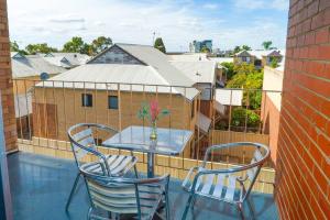 a table and chairs on a balcony with a view at Apartment 12 in Perth