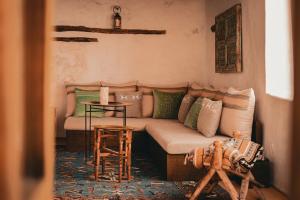 a living room with a couch and a table at Dar Tantora The House Hotel in Al-ʿUla +26 photos
