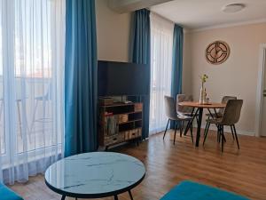 a living room with a table and chairs at Amber drop with a pool in Ravda