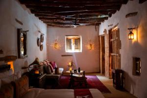 a living room with a couch and a table at Dar Tantora The House Hotel in Al-ʿUla