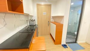 a kitchen with a sink and a glass door at Era Cozy Apartment in Hanoi