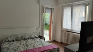 a bedroom with a bed and a large window at Comodità a due passi dal centro di Verbania in Verbania