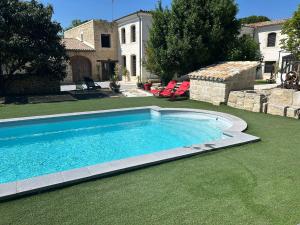 a swimming pool in the yard of a house at Les Marronniers in Lavérune