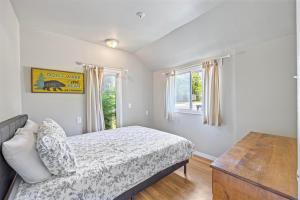 a bedroom with a bed and a window at Riverfront Cottages in Wasaga Beach