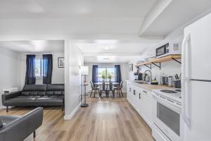 a kitchen and living room with a couch at Riverfront Cottages in Wasaga Beach