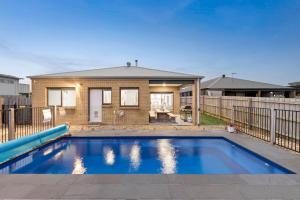 a swimming pool in front of a house at Thyme Out in Cowes