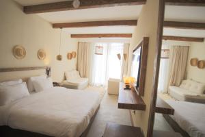 a bedroom with two beds and a living room at Le Sidi Cabana ( hacienda bay ) in El Alamein