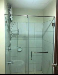 a shower with a glass door in a bathroom at Studio Condo Unit at Horizons 101 in Cebu City