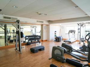 a gym with several treadmills and machines in a room at Thalassa Boutique Hotel & Spa in Coral Bay