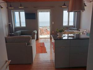 a kitchen and living room with a couch and a table at LimonoSpito in Koroni