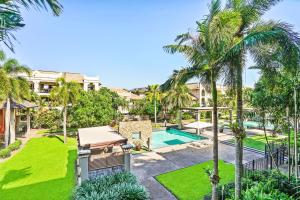 an aerial view of a villa with a swimming pool and palm trees at 116 Cairns One in Cairns