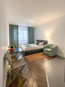 a bedroom with a bed and a table and a chair at Apartments am Wall in Bremen