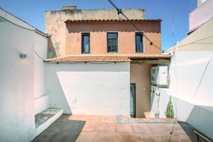a view of a building with a white garage at Sunny & Charming Oeiras Historical Center House in Oeiras