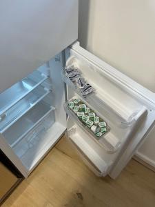 an open refrigerator with some food inside of it at Kettering Service Accomodation 2BRH FreeParking Wifi Smart TV Tea & coffee in Kettering