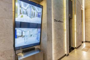 a flat screen tv in a lobby of a building at Desarts Hotel in Seoul +14 photos
