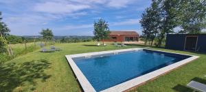 a large swimming pool in a yard with a house at Cascina Rüral in Montafia