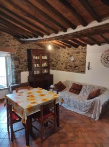a bedroom with a table and a bed in a room at Casa dei nonni 57021 in Campiglia Marittima