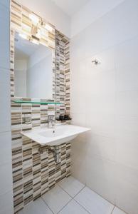 a bathroom with a sink and a mirror at Erato Hotel in Agia Marina Aegina