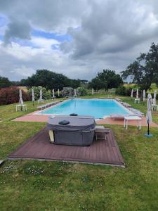 a large grill sitting on a wooden deck next to a swimming pool at Agape in Marco Simone