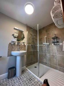 a bathroom with a shower and a sink at Oaklodge House in Leyburn +98 photos