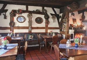 a restaurant with tables and chairs in a room at Altfraenkische Weinstube in Rothenburg ob der Tauber