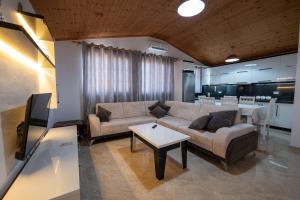 a living room with a couch and a table at Guesthouse Siars in Ksamil