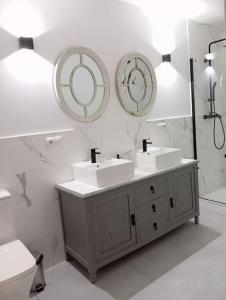 a bathroom with two sinks and a mirror at Casa Mayor in Huérmeces +39 photos