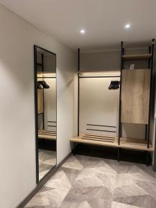a dressing room with mirrors and a tiled floor at Olymp Munich in Eching