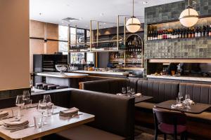 a restaurant with tables and chairs and a bar at Mantra 2 Bond Street in Sydney