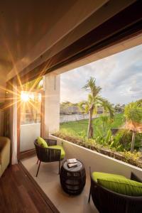 a living room with a large window with a view at Villa Artisane in Seminyak