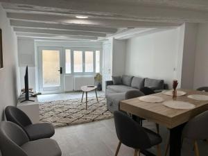 a living room with a table and a couch at Maison hyper centre Jacuzzi in Amboise