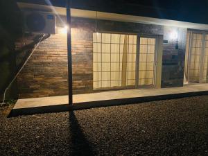 a building with a door on the side of it at night at Sweet Lemon in Batumi