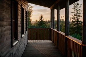 a wooden porch of a house with a view at Grava Cottage in Tukums