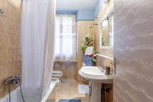 a bathroom with a sink and a toilet and a shower at La Casa Rossa Versilia in Camaiore +17 photos