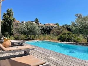 a swimming pool sitting next to a wooden deck at Casa Turrigiani in Sagone