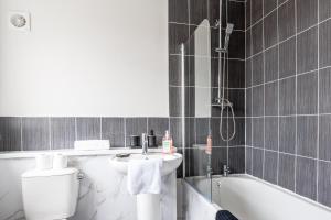 a bathroom with a sink and a toilet and a bath tub at Enjoy a spacious 3 BR home in Sunderland