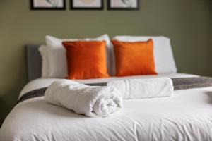 two beds with white towels on top of them at Enjoy a spacious 3 BR home in Sunderland