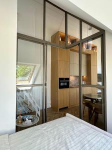 a bedroom with a bed and a dining room at White Penthouse Juodkrante in Juodkrantė