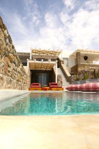 a villa with a swimming pool and a house at Villa Piccolo Mondo in Kalafatis
