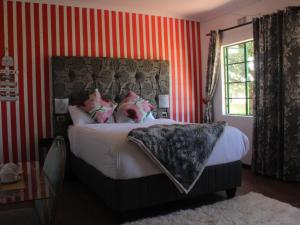 a bedroom with a bed with red and white stripes at Pinetown Accommodation in Pinetown