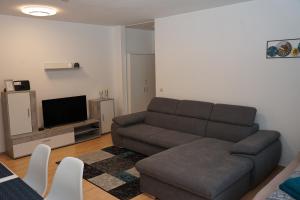 a living room with a couch and a flat screen tv at Moderne Ferienwohnung in Schwandorf in Schwandorf in Bayern