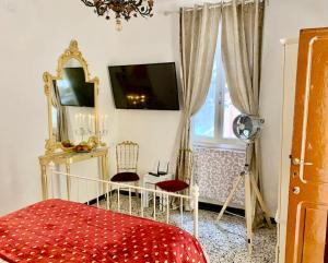a bedroom with a bed and a mirror and a window at Casetta Ambretta in Monterosso al Mare
