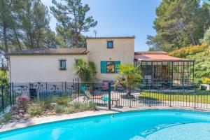 eine Villa mit einem Swimmingpool vor einem Haus in der Unterkunft Gîte proche Aix Marseille piscine in Peypin