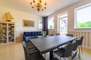 a dining room with a table and chairs at Locmana nams in Liepāja
