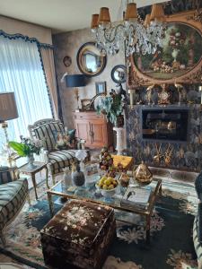 a living room with a couch and a table at les hortensias in Plouvien
