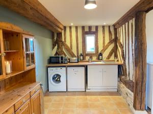 a laundry room with a washer and dryer at Les écuries à 12 mn de Cabourg in Goustranville +43 photos