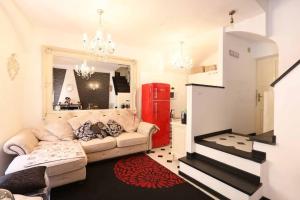 a living room with a couch and a red refrigerator at Casa Giulia in Monterosso al Mare