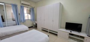 Voodi või voodid majutusasutuse Hello inn 哈囉行旅屏東館 toas