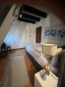 a bedroom with a large bed and a couch at Xantener Ferienhaus Europaplatz 2 in Xanten