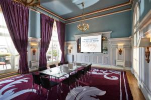 a dining room with a table and chairs at Le Grand Hotel de Cabourg - MGallery Collection in Cabourg